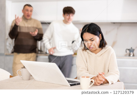 Guy and man quarrel with young woman with laptop 127120379