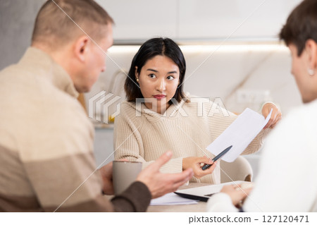 Female realtor tells two men the terms of rental agreement Female realtor tells two men the terms of rental agreement 127120471