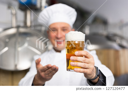 Man brewmaster with glass of beer Man brewmaster with glass of beer 127120477