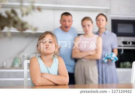 At home kitchen parents scold sitting child for bad behavior at school 127120482