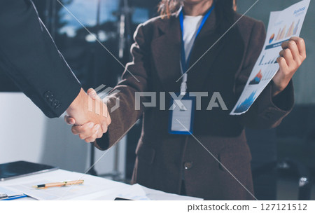 Two businessmen shaking hands after reaching agreement in office Two businessmen shaking hands after reaching agreement in office 127121512
