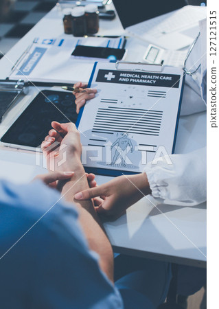 Young brunette woman having consultation at doctor office during 127121515
