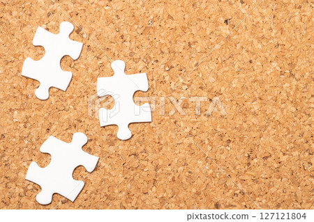 Cork board and white puzzle pieces Cork board and white puzzle pieces 127121804