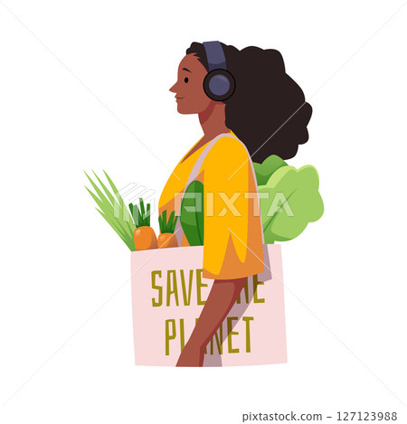 Young woman with headphones and eco bag with vegetables and "Save the Planet" lettering. 127123988