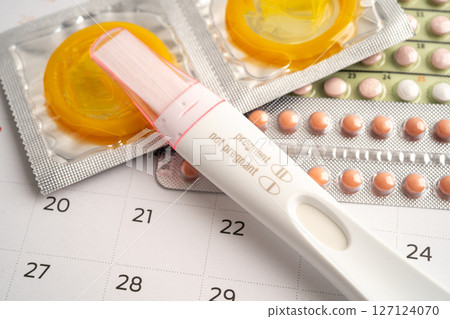 Pregnancy test and birth control pills on calendar, contraception health and medicine. Pregnancy test and birth control pills on calendar, contraception health and medicine. 127124070