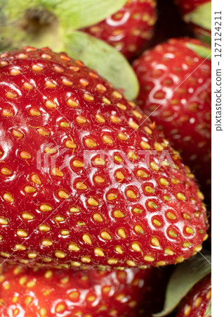 Ripe fresh strawberry macro, clear grains, vertical fruit berry background 127124211