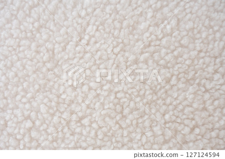 Detailed close-up of plush white sherpa fleece fabric with a wavy, curly pattern Detailed close-up of plush white sherpa fleece fabric with a wavy, curly pattern 127124594