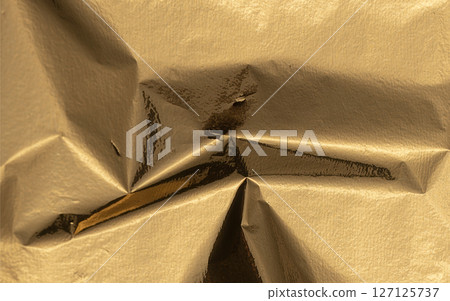 Golden foil texture with a glossy, metallic finish, creating a rich, premium backdrop. Grungy, sleek Golden foil texture with a glossy, metallic finish, creating a rich, premium backdrop. Grungy, sleek 127125737