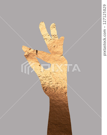 Hand making an OK gesture with gold metallic texture, symbolizing approval and confidence. Elegant, 127125829