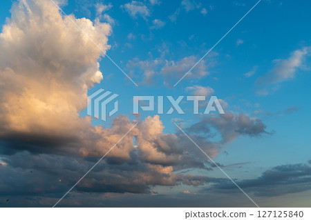 Dramatic evening sky with colorful clouds and blue background. 127125840