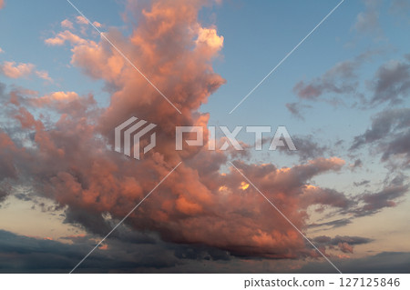 Fiery sunset clouds in dramatic evening sky scene. 127125846