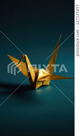 Elegant  origami paper crane with dramatic lighting on dark teal background showcasing traditional Japanese folding art and minimalist aesthetic design 127125857