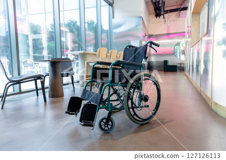 Picture of a wheelchair in the middle of the room 127126113