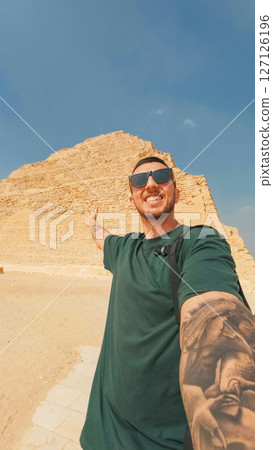 Tourist showing bent pyramid of dahshur, ancient egypt landmark 127126196