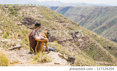 Man and dog admiring the landscape in gorafe, spain 127126204