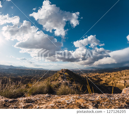 Discovering the majestic badlands of gorafe, spain under a cloudy sky Discovering the majestic badlands of gorafe, spain under a cloudy sky 127126205