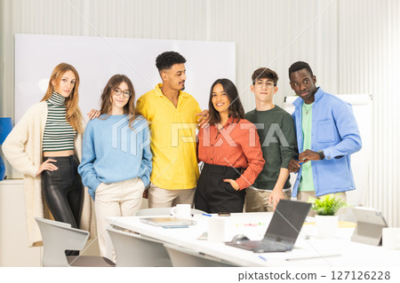 Group of young professionals posing in modern office 127126228