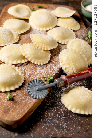 Fresh Homemade Ravioli on Wooden Board 127127089