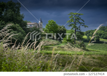 Chateau Tour Baladoz stands majestically under a dramatic sky in the Saint-Emilion wine region Chateau Tour Baladoz stands majestically under a dramatic sky in the Saint-Emilion wine region 127127414