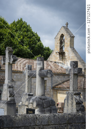 Stone cross cemetery near the church in Saint-Laurent-des-Combes highlighting religious heritage and 127127421