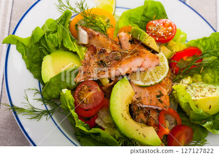 Salad with fried trout, avocado, tomatoes 127127822