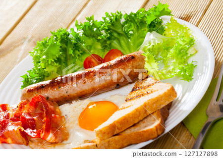 Appetizing breakfast with roasted sausage Appetizing breakfast with roasted sausage 127127898