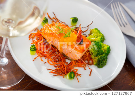 Roasted salmon steak on carrot brushwood with broccoli, cucumber, figs Roasted salmon steak on carrot brushwood with broccoli, cucumber, figs 127127967