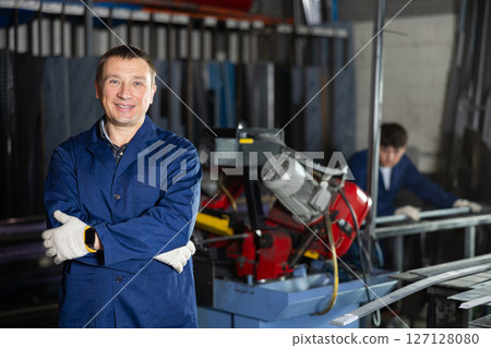 Portrait of male experienced engineer in a robe in workshop of metallurgical plant 127128080
