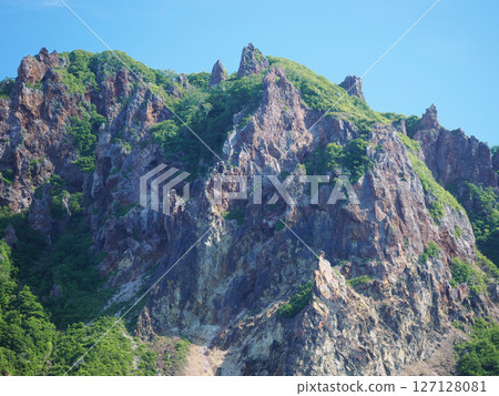 Rocky mountain seen from a boat in the sea of Otaru 127128081