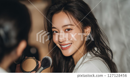 Smiling woman enjoying a beauty session in a warm and inviting setting 127128456