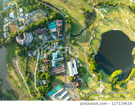 Aerial view drone shot of beautiful green golf field fairway and putting green,Top down image for sport background and travel nature background. Aerial view drone shot of beautiful green golf field fairway and putting green,Top down image for sport background and travel nature background. 127129619