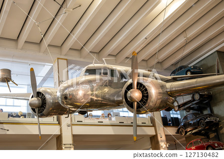 The Lockheed 10a Electra is prominently displayed in London's Science Museum, showcasing its vintage aviation design and engineering. Visitors admire its sleek silver body and propellers. The Lockheed 10a Electra is prominently displayed in London's Science Museum, showcasing its vintage aviation design and engineering. Visitors admire its sleek silver body and propellers. 127130482