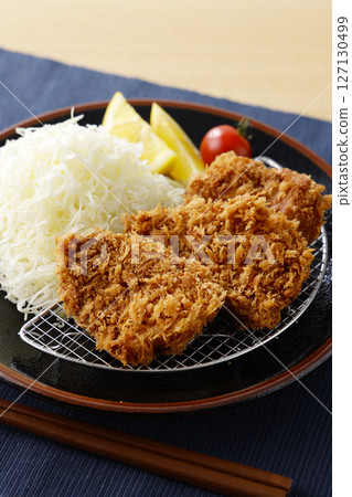 Delicious pork fillet cutlet served on a plate 127130499