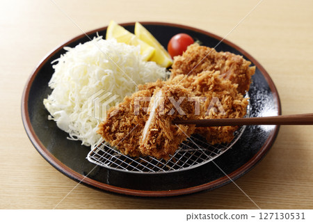 Delicious pork fillet cutlet served on a plate 127130531