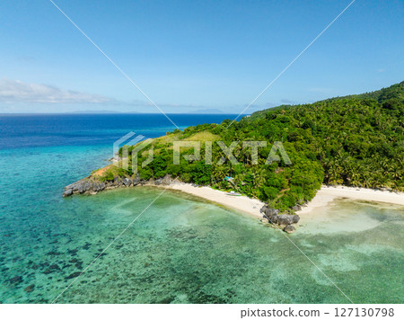 Sandy beach with turquoise sea water and corals. Cobrador Island. Romblon, Philippines. 127130798