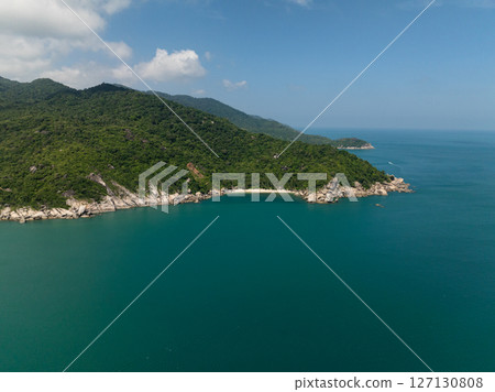 Aerial view of hidden bays surrounded by green hills and turquoise sea under a clear blue sky. Head khontee. Ko Pha Ngan, Thailand. Aerial view of hidden bays surrounded by green hills and turquoise sea under a clear blue sky. Head khontee. Ko Pha Ngan, Thailand. 127130808