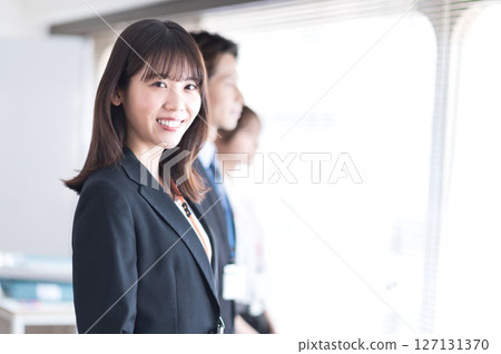 Young woman in a suit looking at camera Young woman in a suit looking at camera 127131370