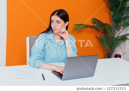 Business brunette woman working on laptop at office desk online 127131515