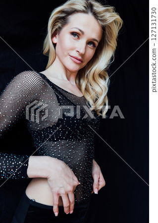 Beautiful fashionable blonde in a black evening suit 127131730