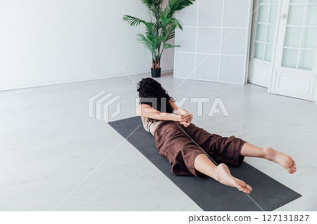 Fitness Woman Brunette Doing Gymnastics Yoga Asana in White Hall 127131827