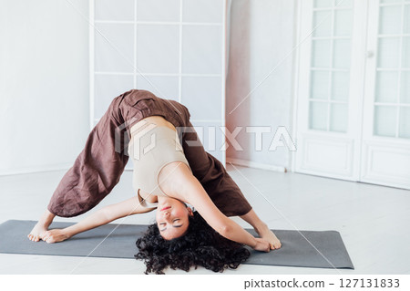 Fitness Curly Brunette Woman Doing Gymnastics Yoga Asana 127131833