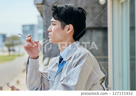 Young man smoking outside Young man smoking outside 127131932