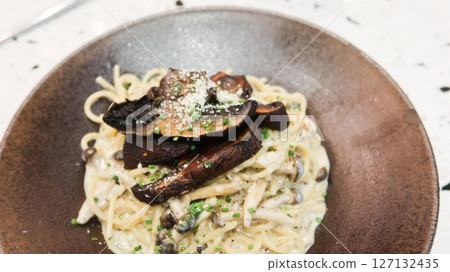 close up of white cream sauce black truffle mushroom pasta spaghetti with copy space close up of white cream sauce black truffle mushroom pasta spaghetti with copy space 127132435