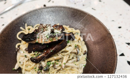 close up of white cream sauce black truffle mushroom pasta spaghetti with copy space close up of white cream sauce black truffle mushroom pasta spaghetti with copy space 127132436