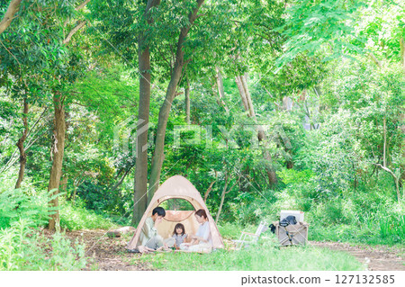 Family with children enjoying camping in the woods 127132585