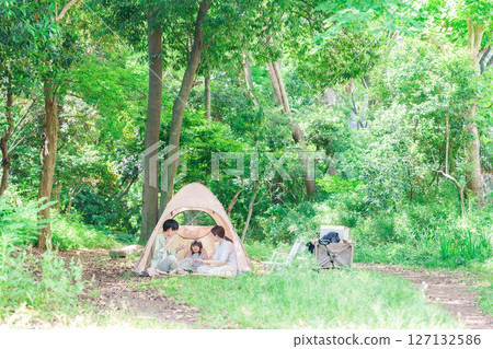 Family with children enjoying camping in the woods Family with children enjoying camping in the woods 127132586
