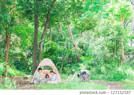 Family with children enjoying camping in the woods 127132587