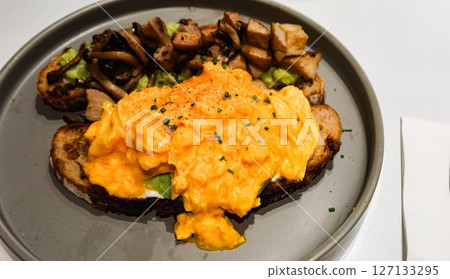 close up of a scramble egg toast and stir fried mushroom avocado toast with copy space close up of a scramble egg toast and stir fried mushroom avocado toast with copy space 127133295