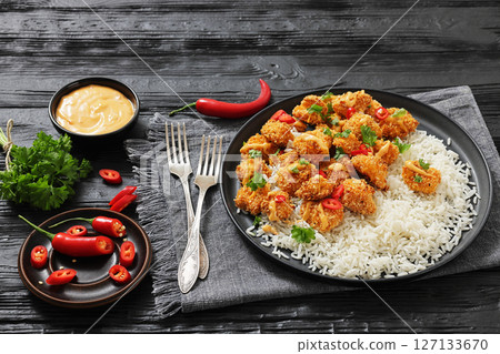 panko-breaded chicken bites with rice and sauce 127133670
