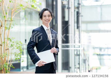 Businessmen working in an office. Filming cooperation: SKY Perfect Tokyo Media Center 127134156